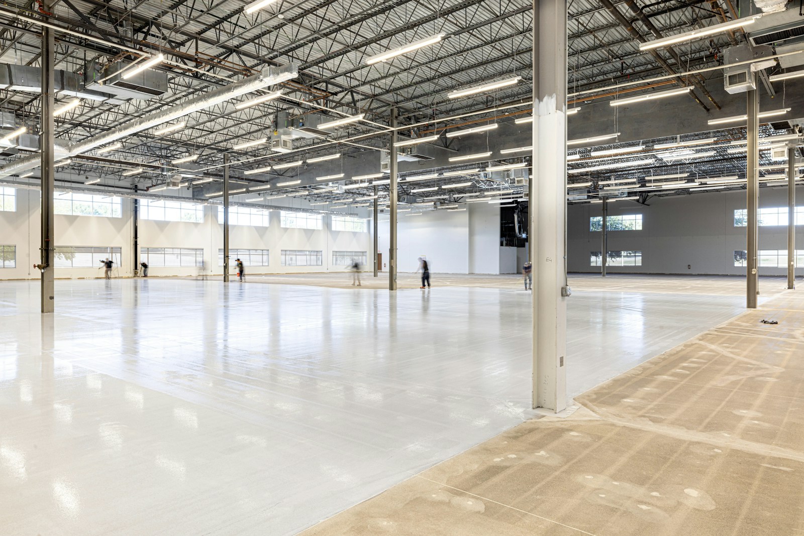 Empty, modern warehouse interior with polished concrete floor